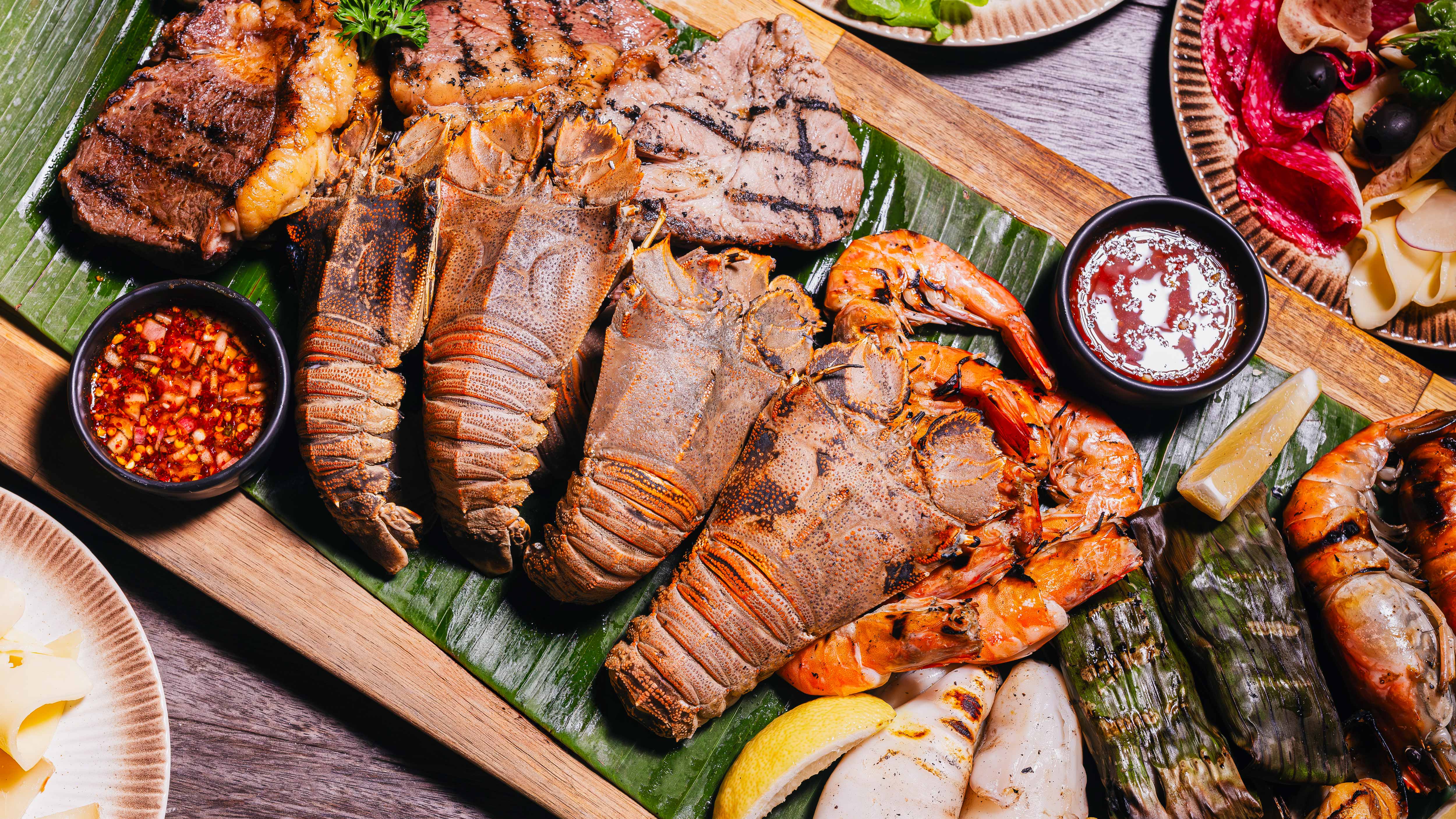Experience SeaFest Night with Phuket seafood, premium oysters, Raclette, Beef Pho, fine cheeses and global comfort bites, freshly prepared at joyful live cooking stations.